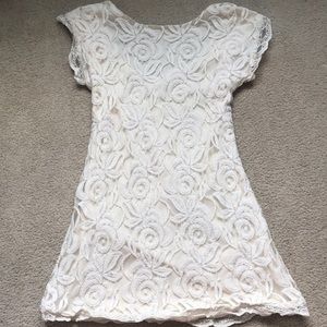Low back, white lace dress.